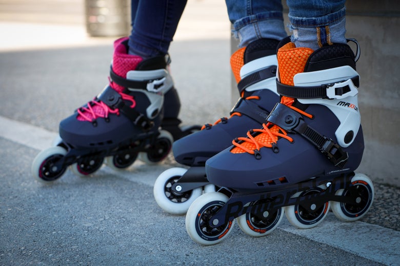 Closeup shot of two people wearing Rollerblade Maxxum inline skates on their feet