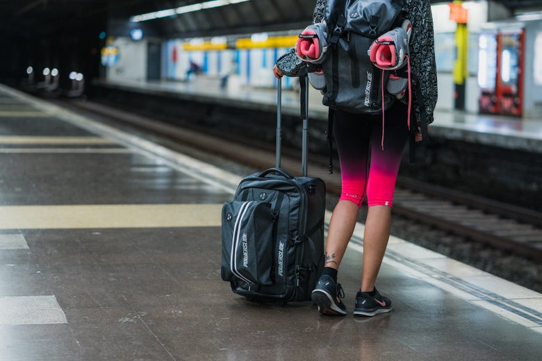 Lady standing with UBC Transit and UBC Road Runner Base Bags