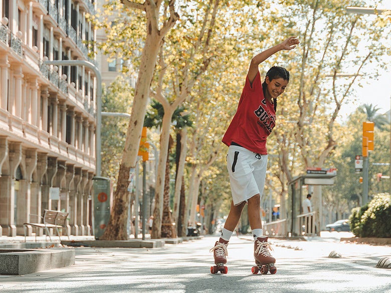 Rollerskater skating down the street in Chaya Cozy Wine Skates
