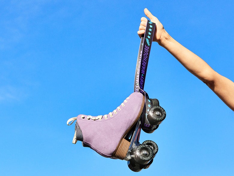 a hand holding a skate leash with chuffed skates