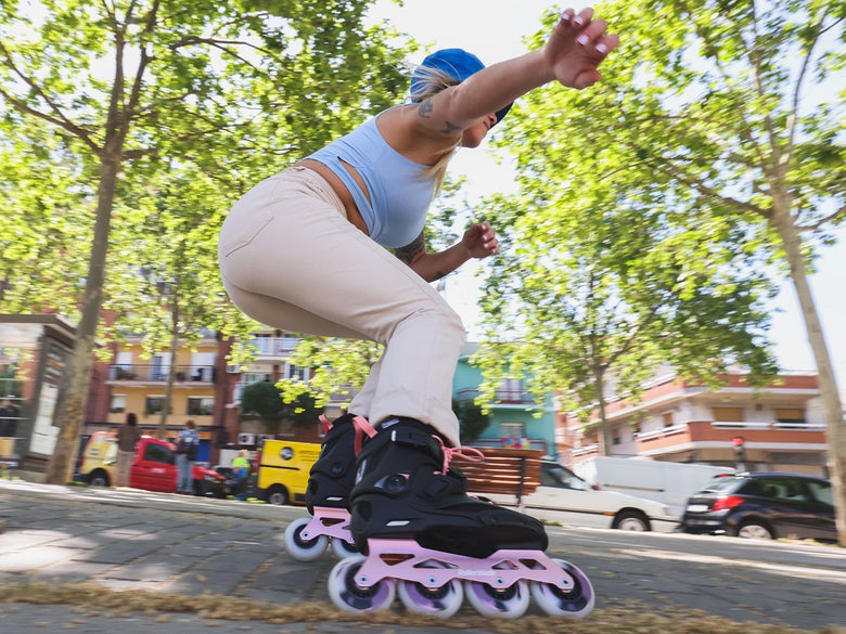 Female inline skater on a city sidewalk