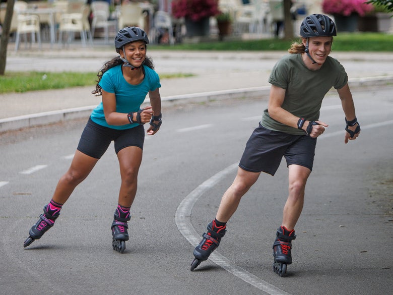 Two inline skaters on a bike path