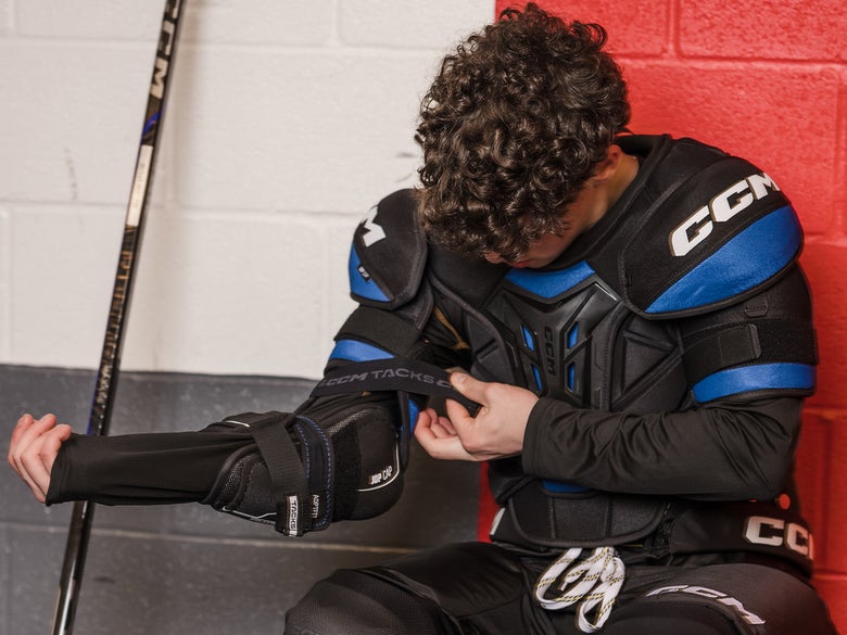 Hockey player getting ready in a locker room 