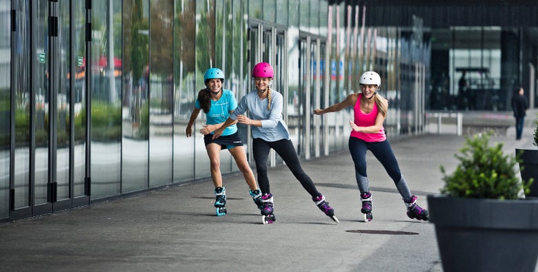 Women fitness skating on the sidewalk