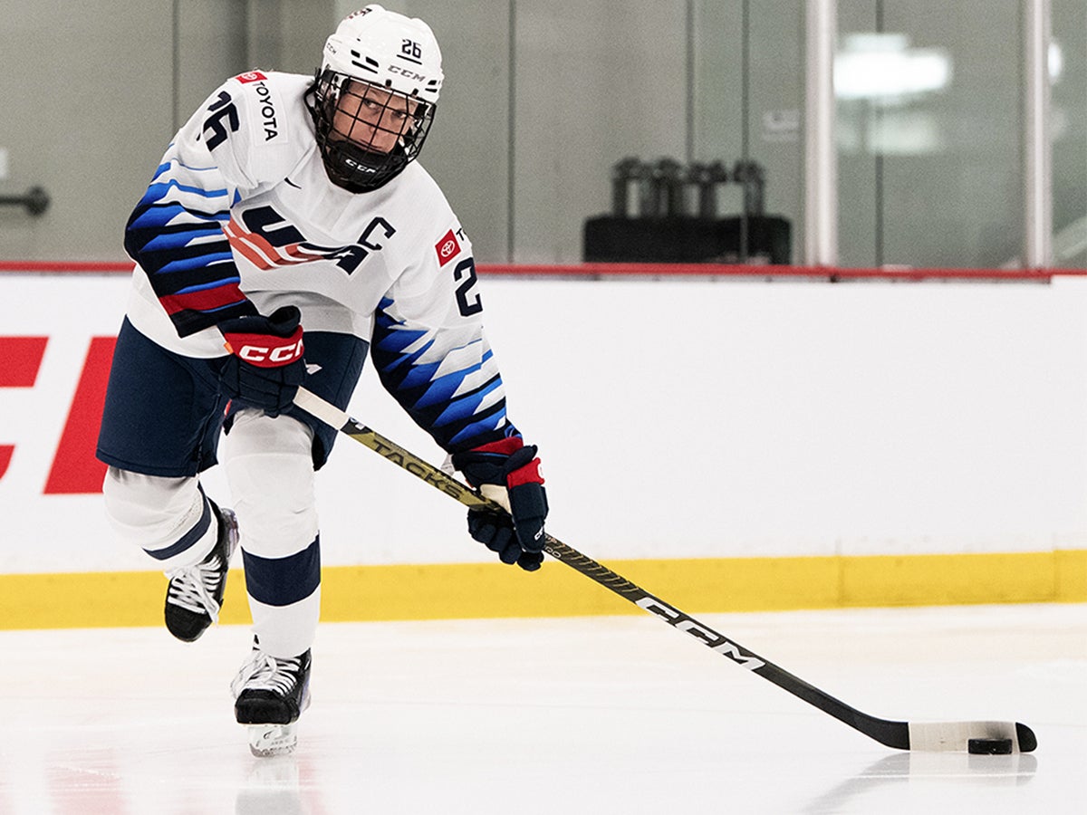 Women's Hockey Player shooting the puck